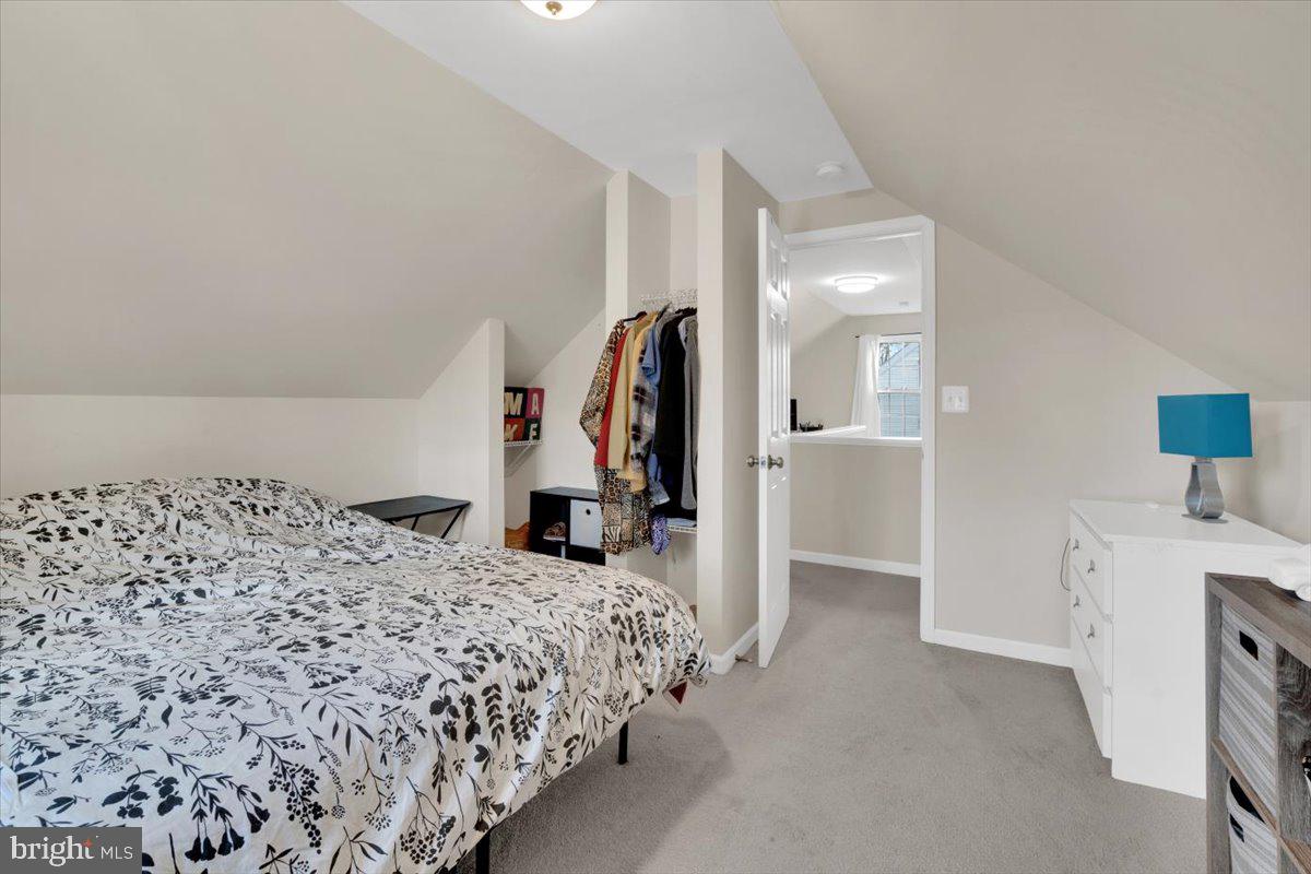 6519 Woodland Road Suitland, MD 20746 - Photo 19 of 35 a bed room with a bed and a view of bedroom