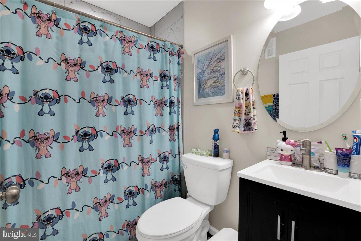 6519 Woodland Road Suitland, MD 20746 - Photo 20 of 35 a bathroom with a sink and a mirror