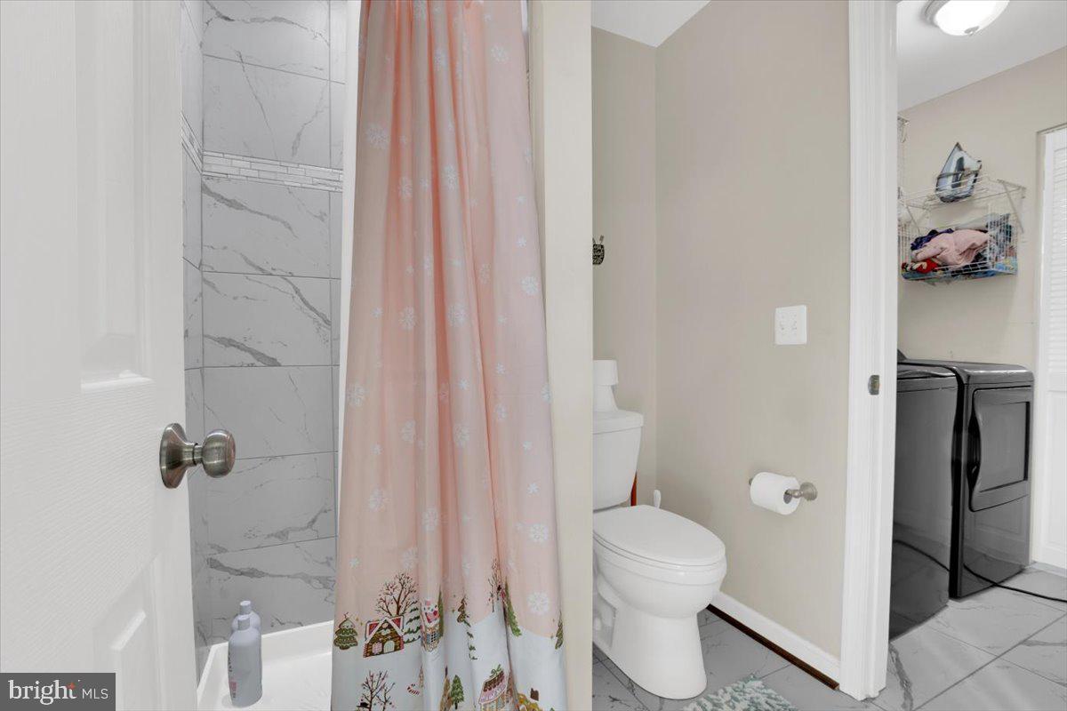 6519 Woodland Road Suitland, MD 20746 - Photo 24 of 35 a bathroom with a toilet and a shower