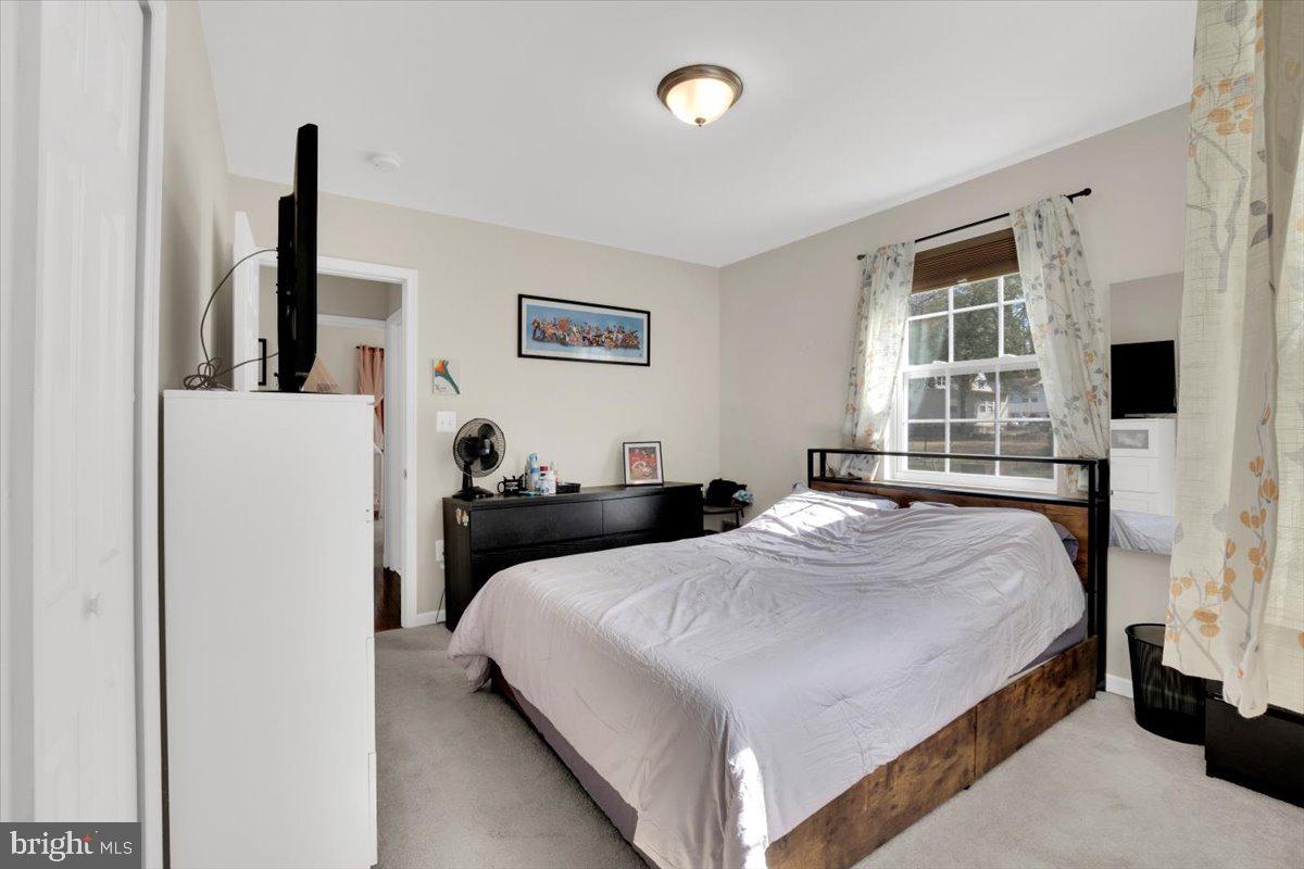 6519 Woodland Road Suitland, MD 20746 - Photo 25 of 35 a bedroom with a bed and a flat screen tv