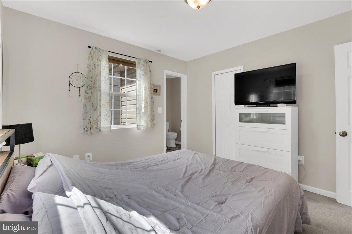 6519 Woodland Road Suitland, MD 20746 - Photo 26 of 35 a bedroom with a bed and a flat screen tv