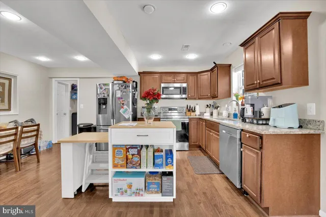 a kitchen with cabinets and wooden floor