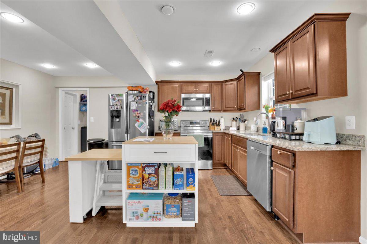 6519 Woodland Road Suitland, MD 20746 - Photo 5 of 35 a kitchen with cabinets and wooden floor