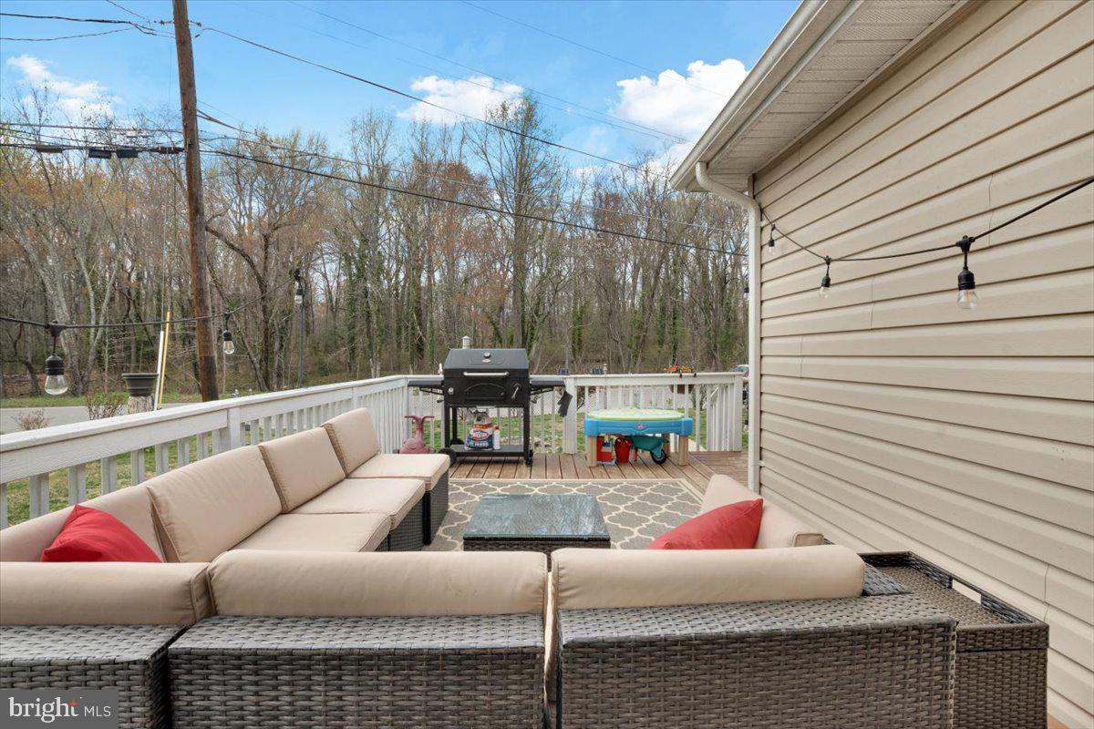 6519 Woodland Road Suitland, MD 20746 - Photo 6 of 35 a outdoor space with patio the couch and chairs