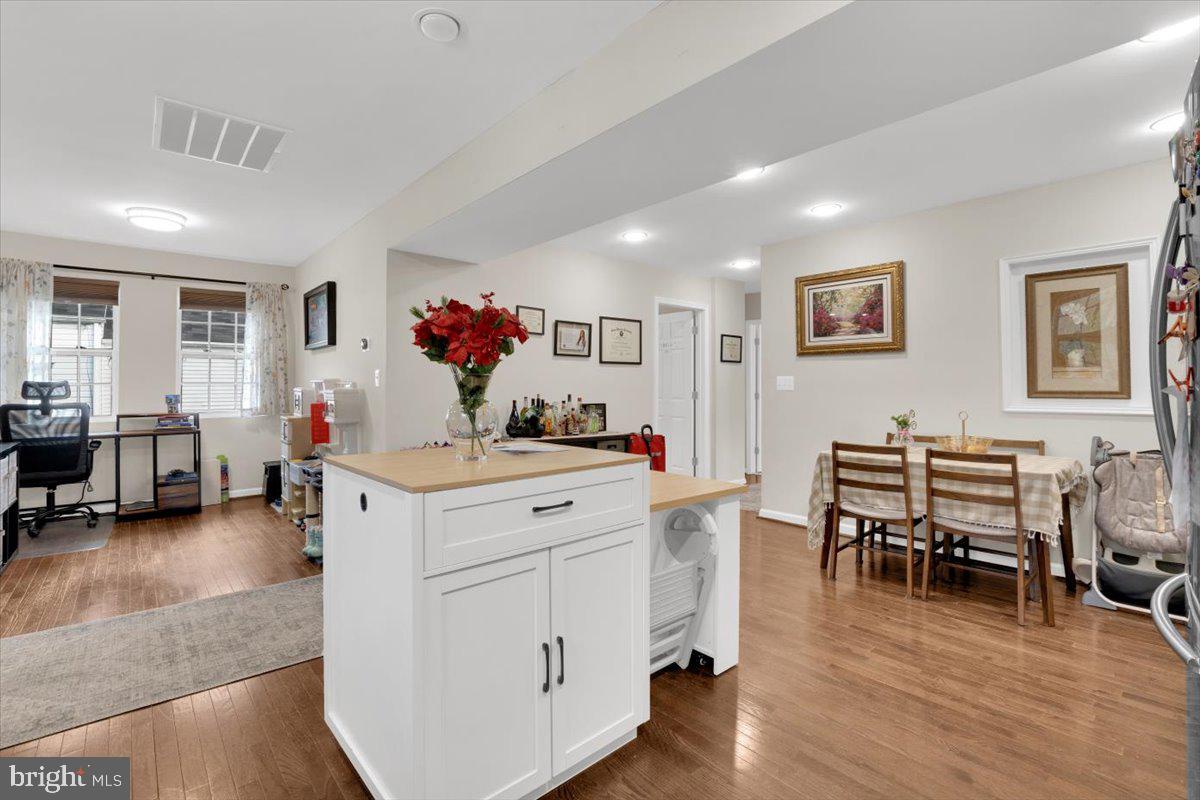 6519 Woodland Road Suitland, MD 20746 - Photo 7 of 35 a view of a dining room with furniture and wooden floor