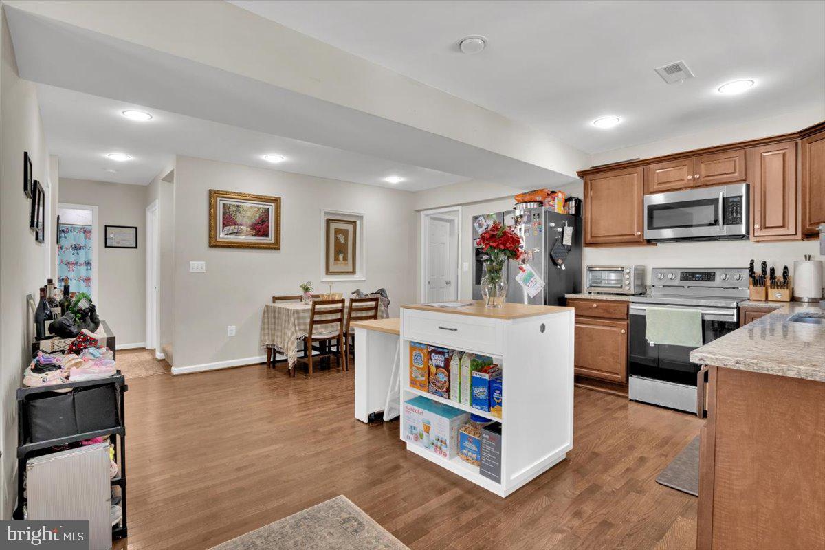 6519 Woodland Road Suitland, MD 20746 - Photo 9 of 35 a living room with stainless steel appliances furniture and a kitchen view