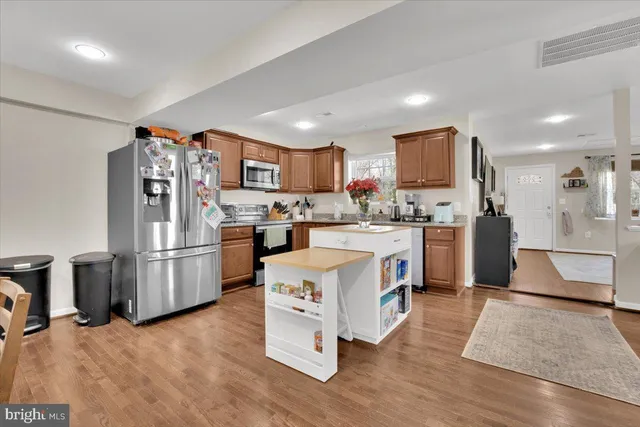 a kitchen with a sink a refrigerator and a stove top oven