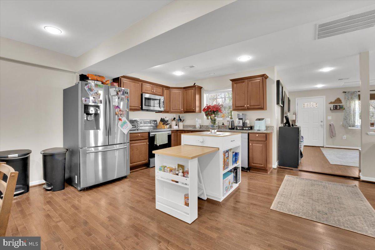 6519 Woodland Road Suitland, MD 20746 - Photo 10 of 35 a kitchen with a sink a refrigerator and a stove top oven