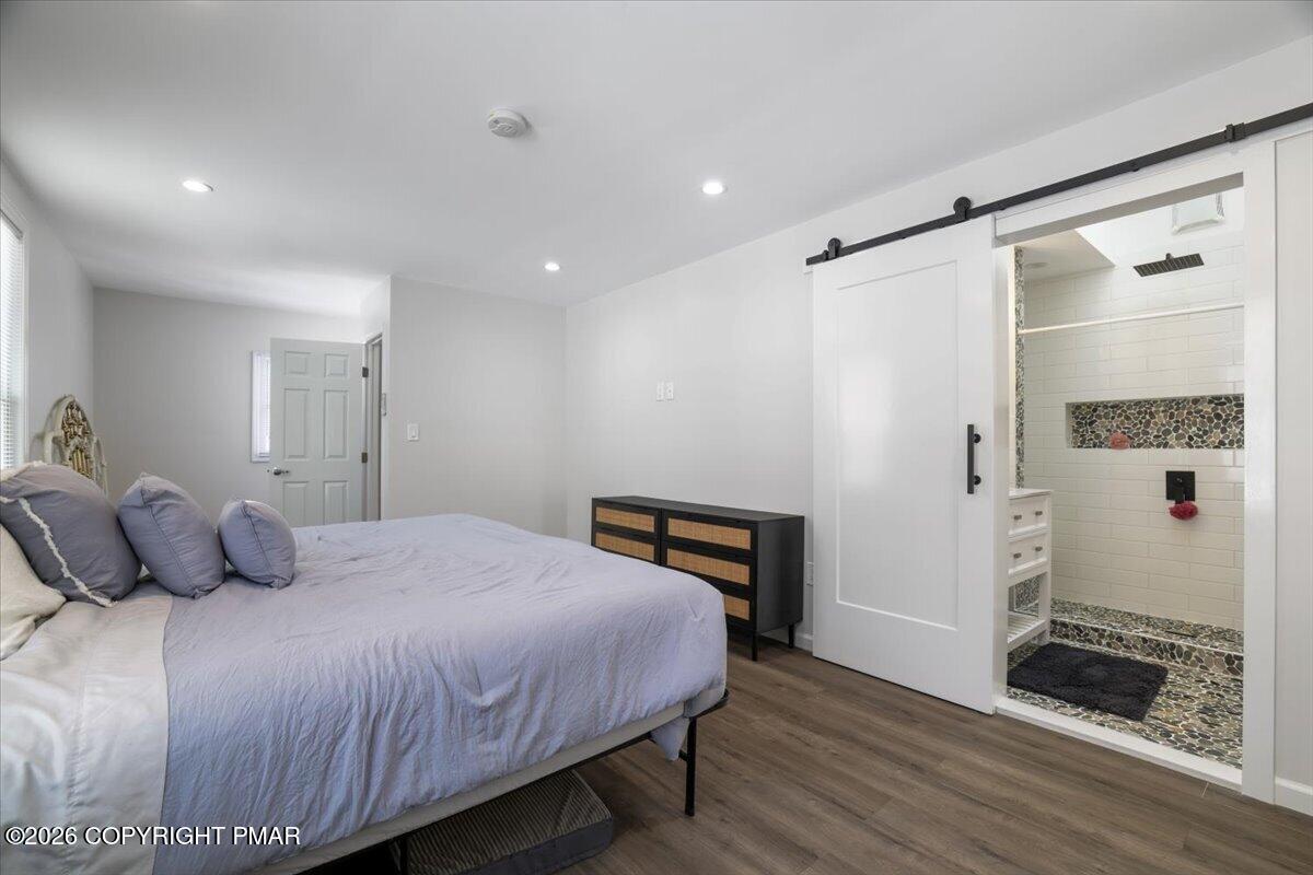 5873 Decker Road Bushkill, PA 18324 - Photo 6 of 57 a bedroom with a bed and wooden floor