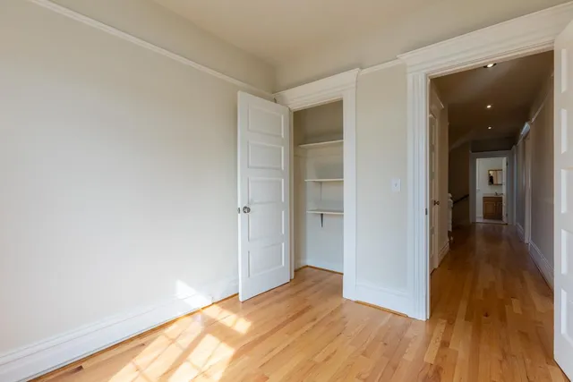 a view of hallway with wooden floor