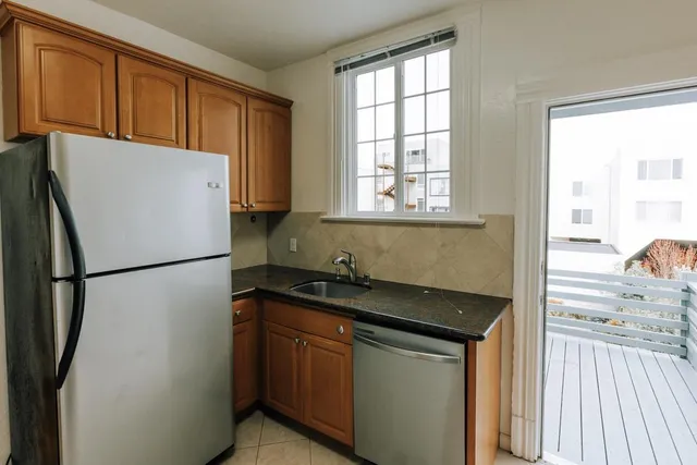a white refrigerator freezer sitting inside of a kitchen