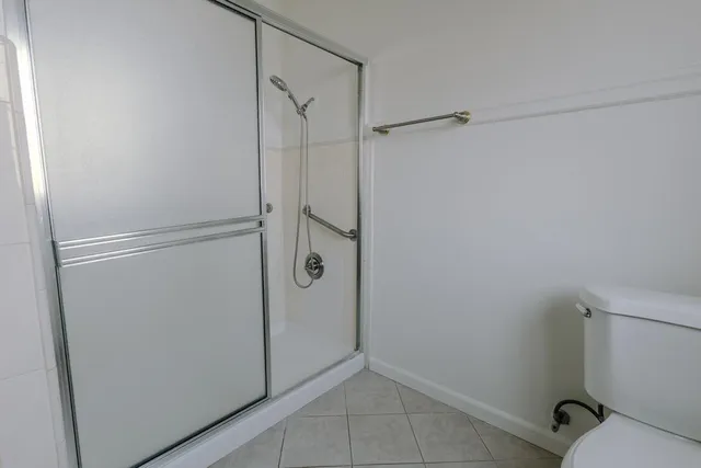 a bathroom with a glass shower door