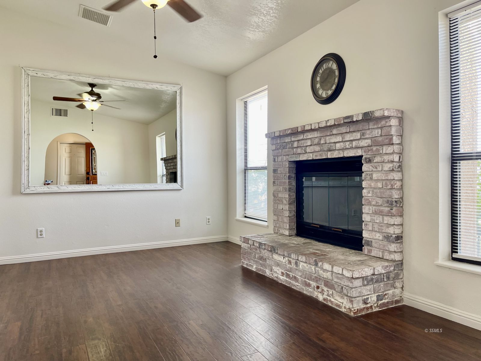 225 Michele Street Ridgecrest, CA 93555 - Photo 13 of 36 a living room with a fireplace with wooden floor