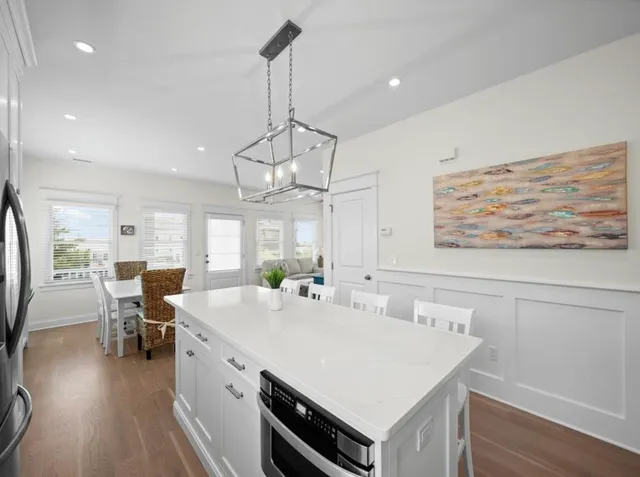 a large kitchen with a table and chairs