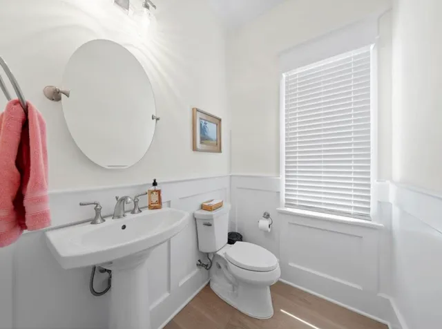 a bathroom with a sink a toilet and a mirror