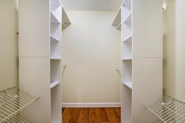 a view of walk in closet with empty racks
