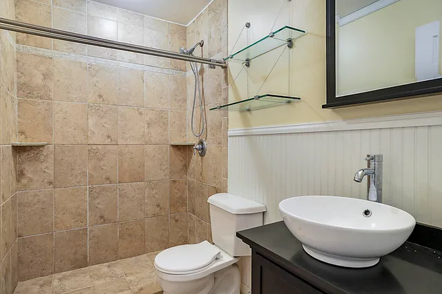 a bathroom with a sink toilet and shower