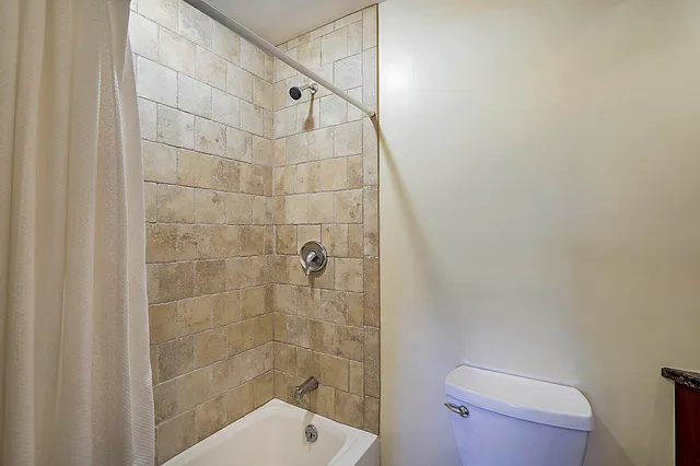 a bathroom with a shower and toilet