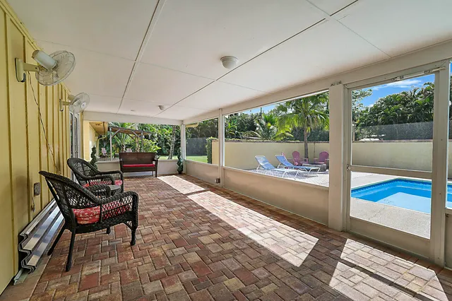 a living room with furniture and a floor to ceiling window