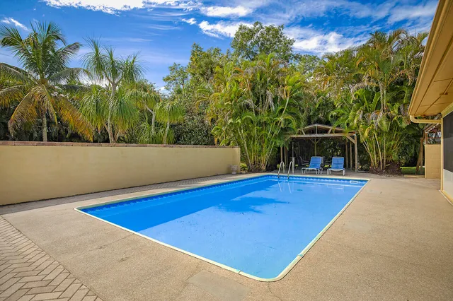 a view of a swimming pool with an outdoor space and seating area