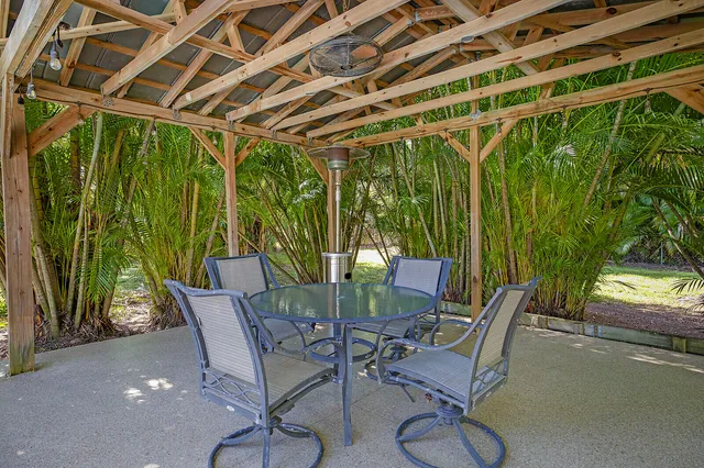 a view of a chairs and table in patio