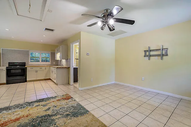 a living room with stainless steel appliances kitchen island granite countertop furniture and a view of kitchen