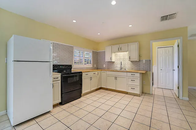 a kitchen with a sink cabinets and stainless steel appliances