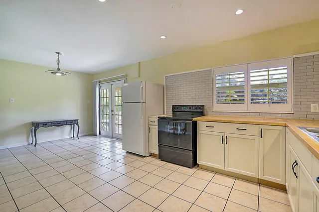 a kitchen with a stove a sink and a refrigerator