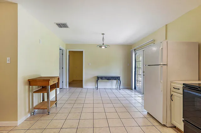 a view of a kitchen with refrigerator and chair