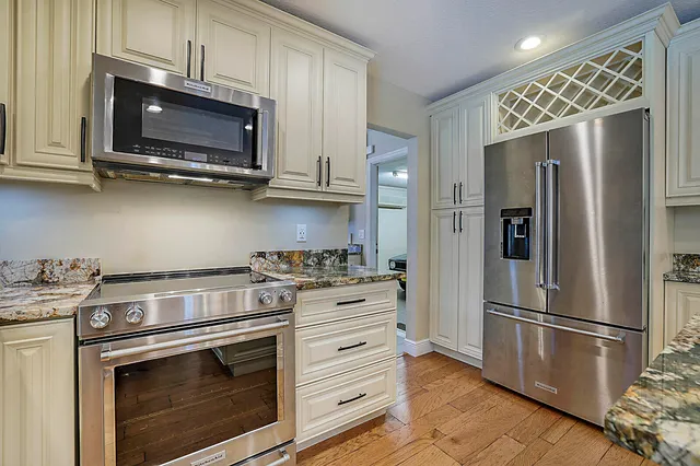 a kitchen with stainless steel appliances a stove a microwave and a refrigerator