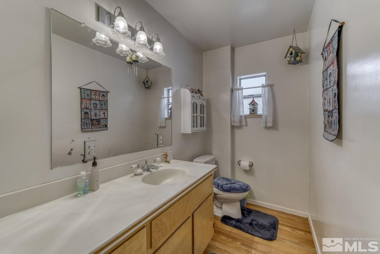 3650 Clover Way Reno, NV 89509 - Photo 15 of 31 a bathroom with a sink a toilet and a mirror