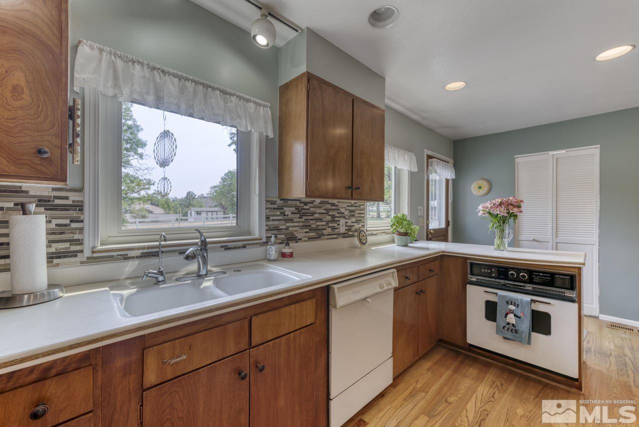 3650 Clover Way Reno, NV 89509 - Photo 6 of 31 a kitchen with a sink stove and cabinets