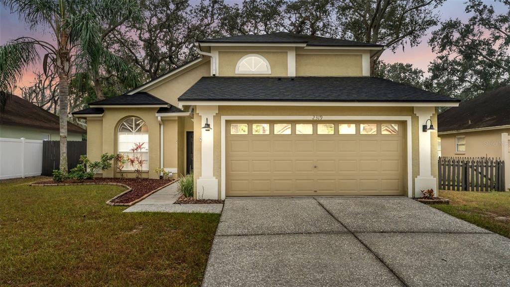 2319 Needham Drive Valrico, FL 33596 - Photo 1 of 35 a front view of a house with garden
