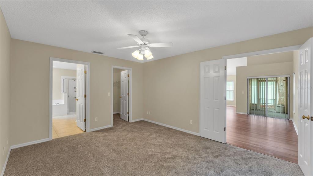 2319 Needham Drive Valrico, FL 33596 - Photo 14 of 35 an empty room with wooden floor and ceiling fan