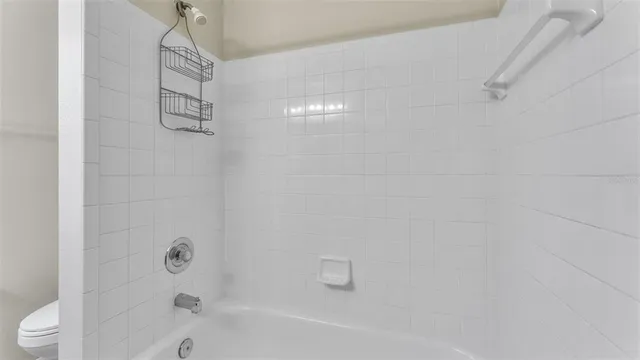 a bathroom with a bathtub and shower