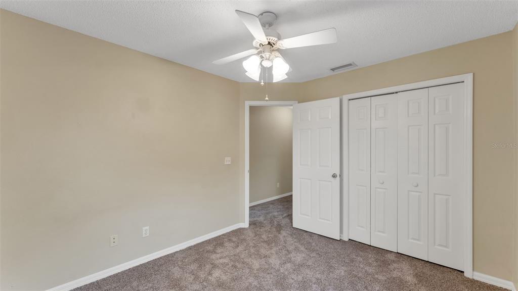 2319 Needham Drive Valrico, FL 33596 - Photo 24 of 35 an empty room with a ceiling fan and a window