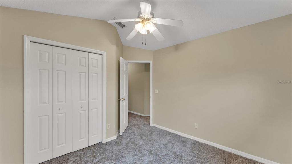 2319 Needham Drive Valrico, FL 33596 - Photo 26 of 35 a view of an empty room and a chandelier fan