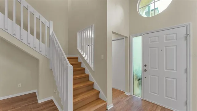 a view of staircase with white walls and wooden floor