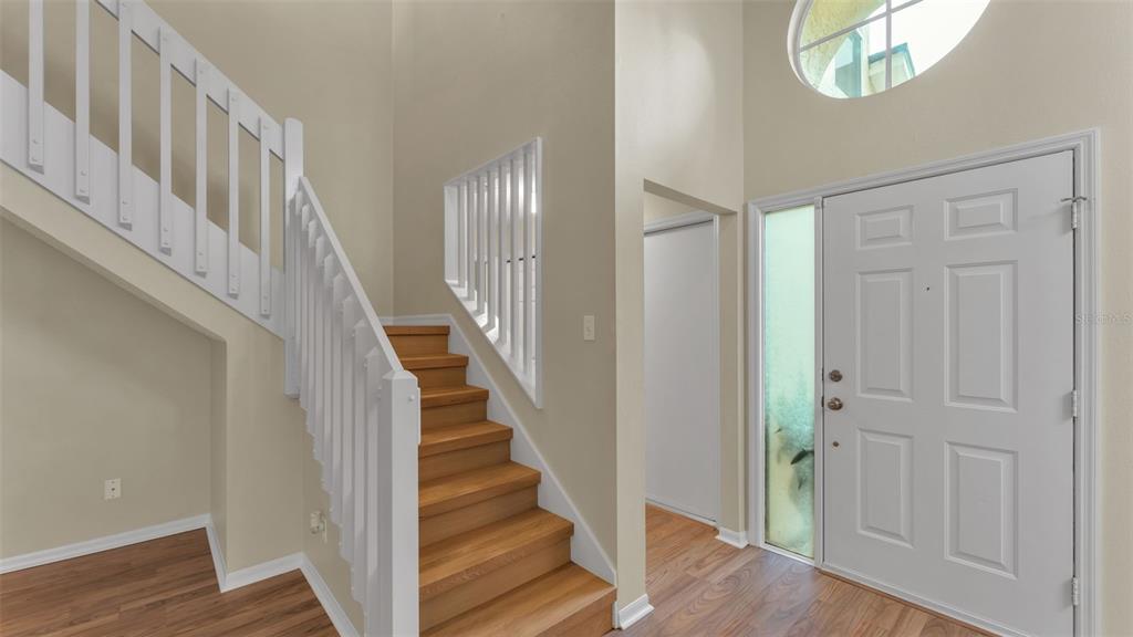 2319 Needham Drive Valrico, FL 33596 - Photo 3 of 35 a view of staircase with white walls and wooden floor