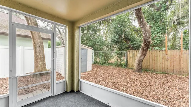 a large bed sitting in a bedroom next to a large window