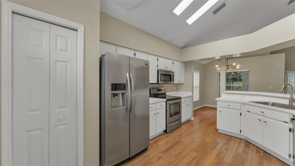2319 Needham Drive Valrico, FL 33596 - Photo 5 of 35 a kitchen with stainless steel appliances a refrigerator sink and cabinets