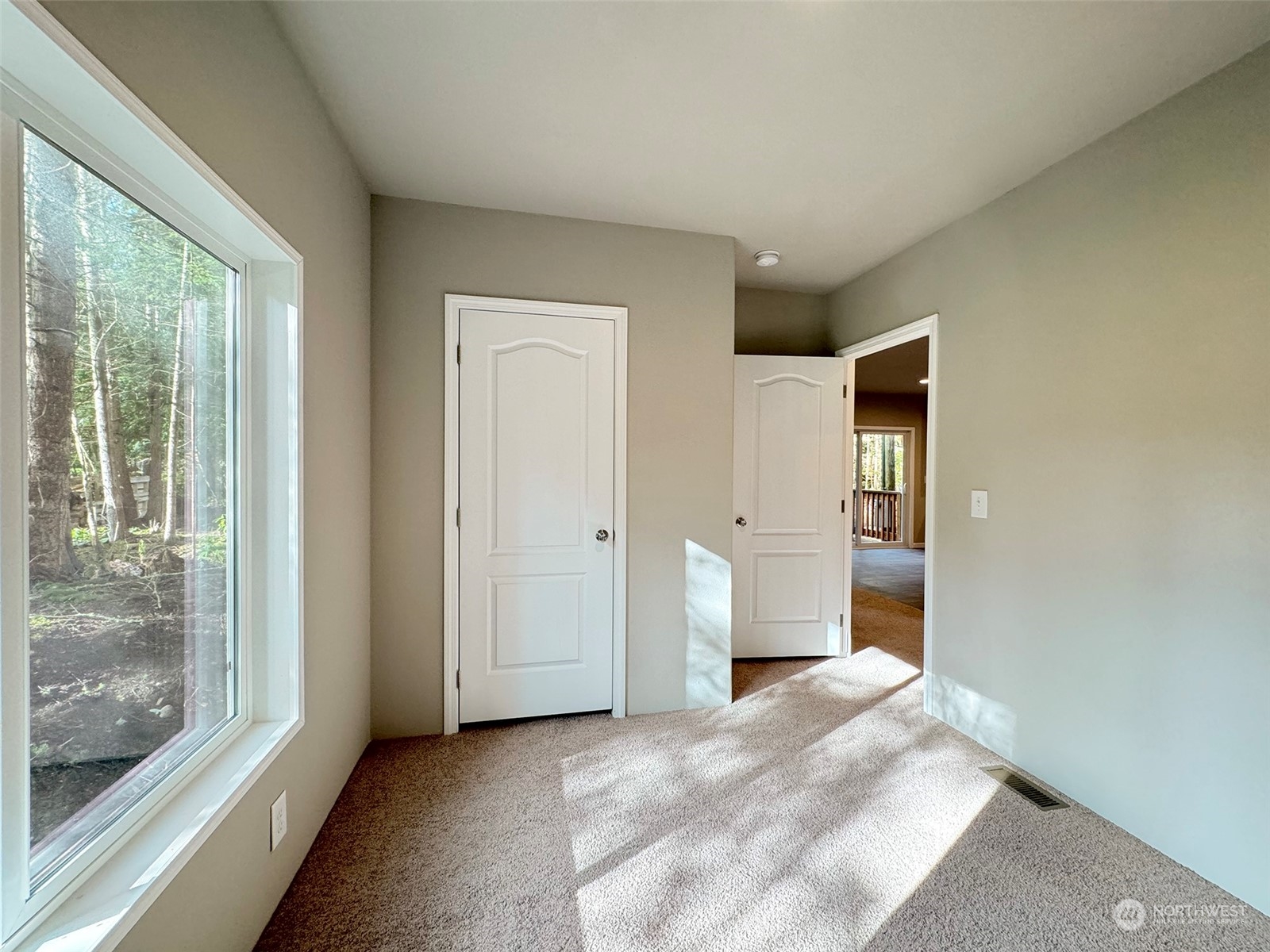180 Madrona Way Sequim, WA 98382 - Photo 17 of 35 a view of a big room with wooden floor and windows