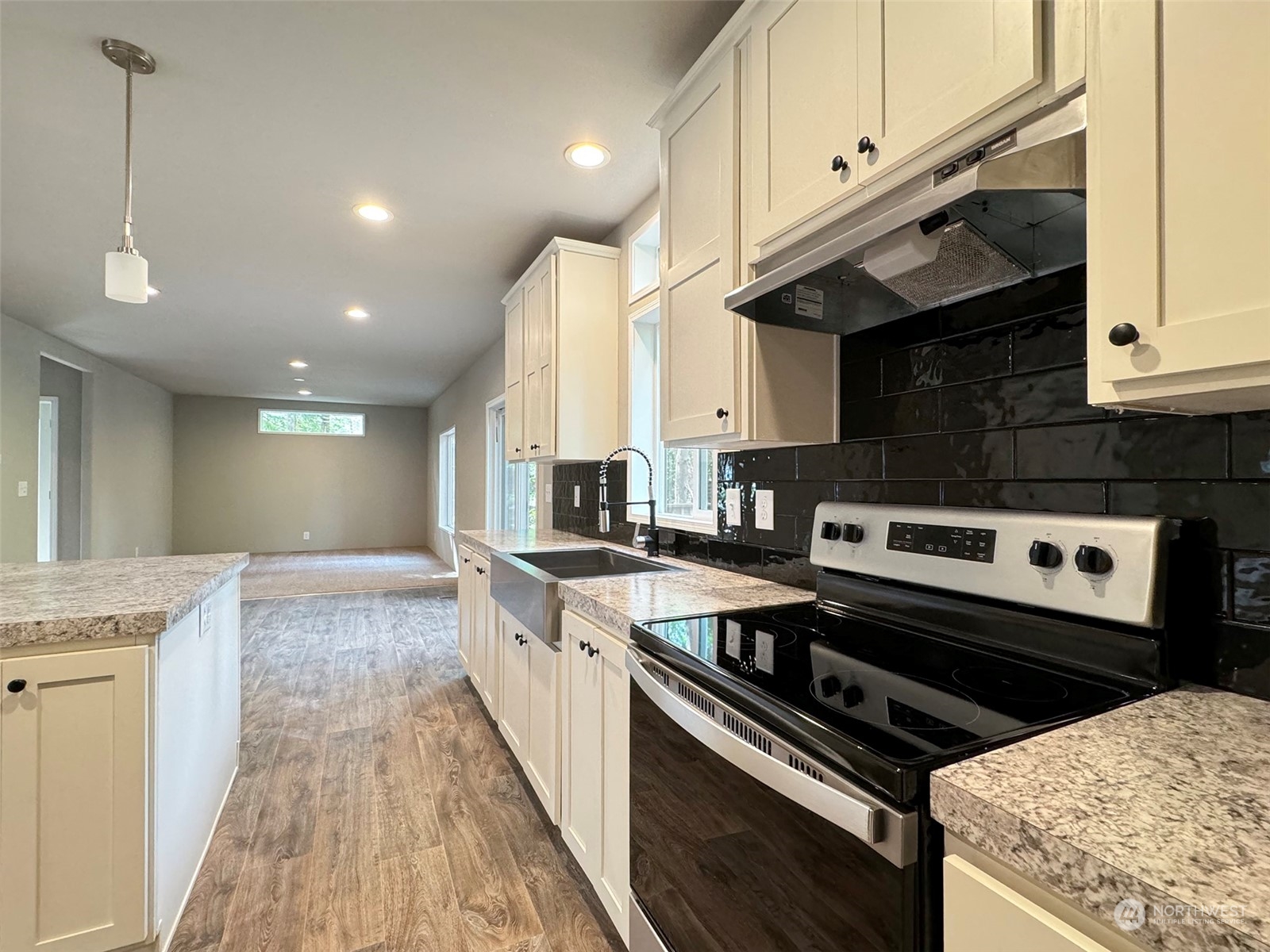 180 Madrona Way Sequim, WA 98382 - Photo 7 of 35 a kitchen with stainless steel appliances granite countertop a stove a sink and a microwave