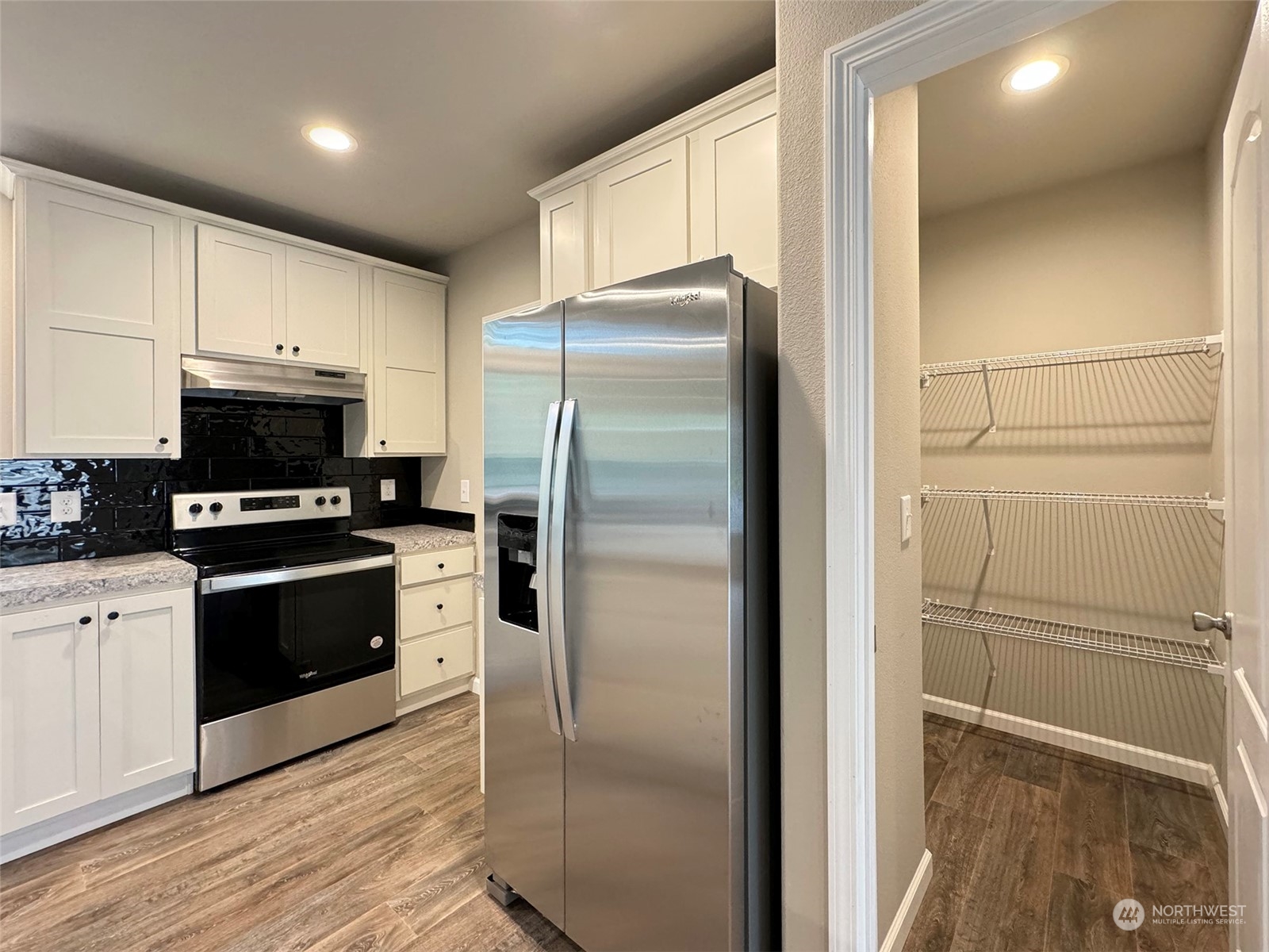 180 Madrona Way Sequim, WA 98382 - Photo 8 of 35 a kitchen with a refrigerator a sink and a stove top oven