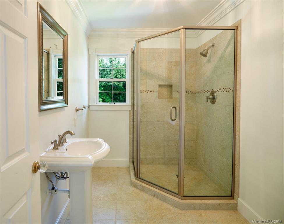 296 North Corner Estates Road Lancaster, SC 29720 - Photo 14 of 24 a bathroom with a shower a mirror and a sink