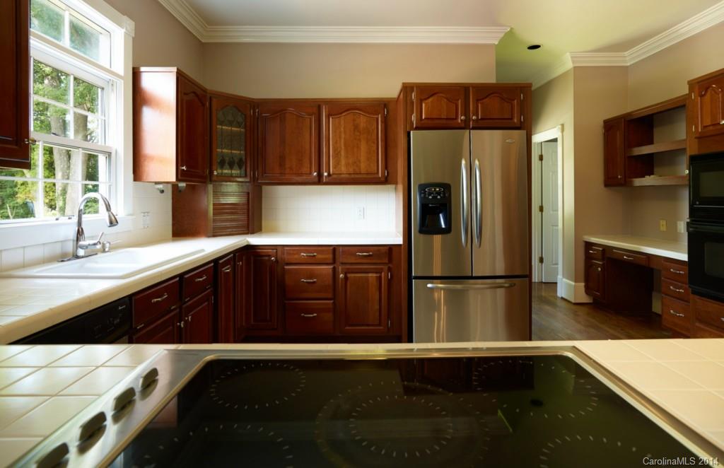 296 North Corner Estates Road Lancaster, SC 29720 - Photo 8 of 24 a kitchen with a refrigerator and a sink