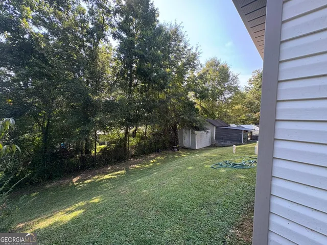 a view of a backyard of the house