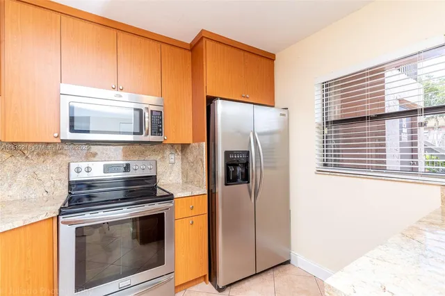 a kitchen with stainless steel appliances a stove microwave and refrigerator