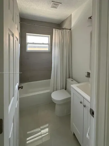 a bathroom with a bathtub a toilet and a shower