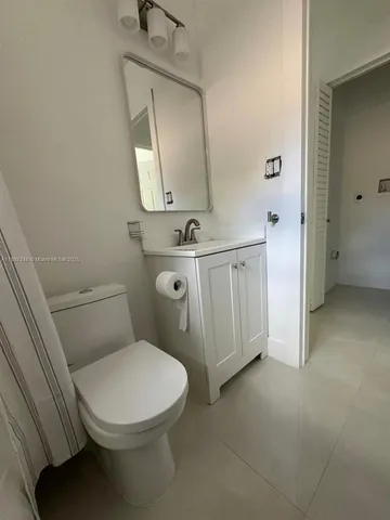 a white toilet sitting next to a bathroom sink